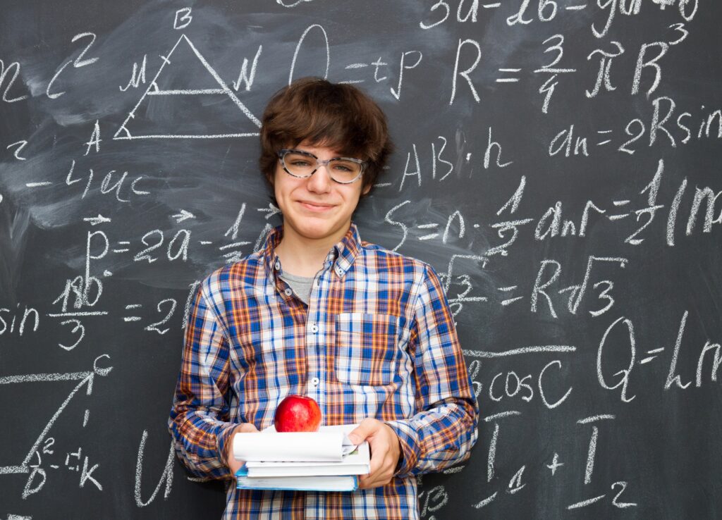 Boy and blackboard filled with math formulas