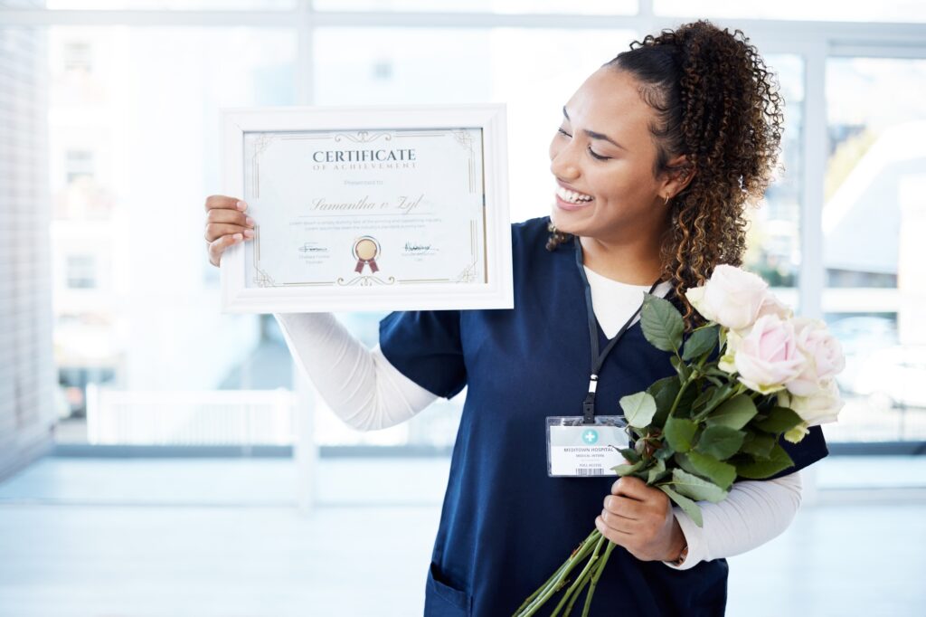 Certificate, flowers and a black woman graduate in the hospital feeling proud of her achievement. S