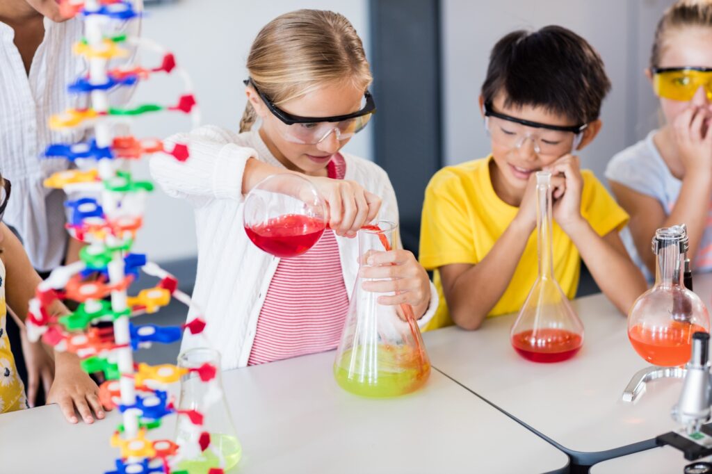 Pupil doing science while classmates looking her